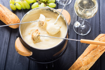 Cheese fondue with bread wine and grape