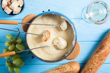 Cheese fondue with bread wine and grape