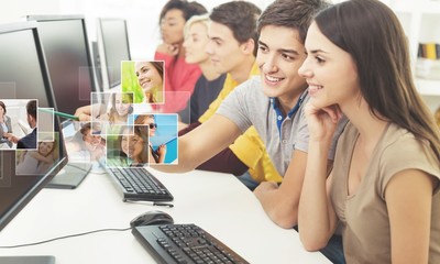 Group of Students with computers at lesson in classroom