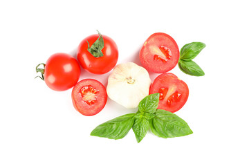 Fresh cherry tomatoes with basil and garlic isolated on white background, top view. Ripe vegetables