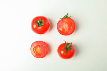 Flat lay composition with fresh cherry tomatoes on white background, space for text. Ripe vegetables