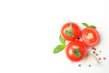 Fresh cherry tomatoes with basil, pepper and garlic on white background, space for text and top view. Ripe vegetables