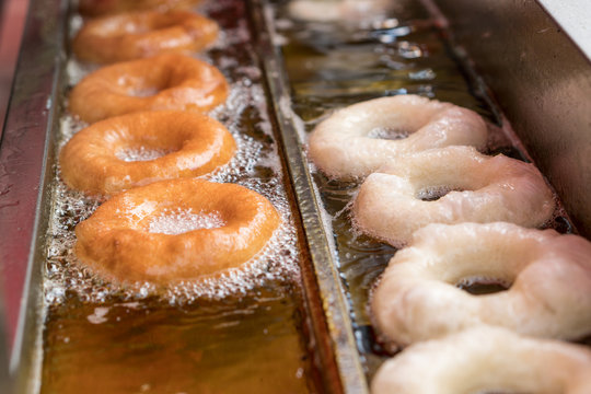Preparation of fried donuts in a hot oil.