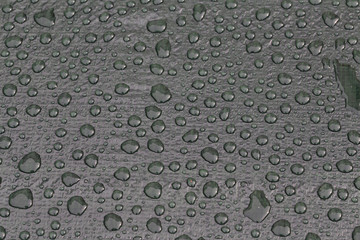 Large drops of water on plastic film after rain