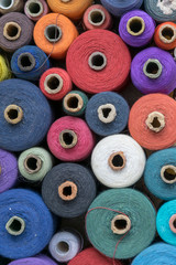 multicolor skeins and coils of threads. atelier sewing accessories background top view