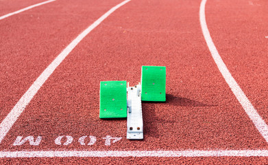 Starting blocks on red track at 400 meter start line