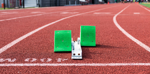 Starting blocks at the 400m start on a red track