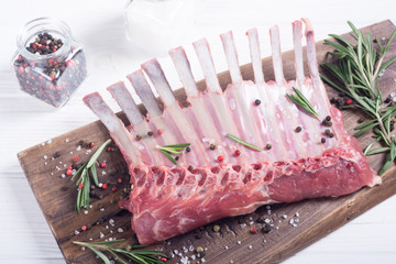 Raw rack of lamb with spices and herbs