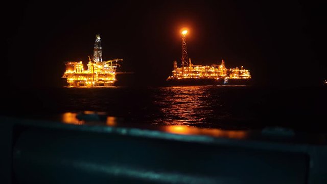 FPSO tanker vessel near Oil platform Rig. Offshore oil and gas industry, sea oil production and storage.