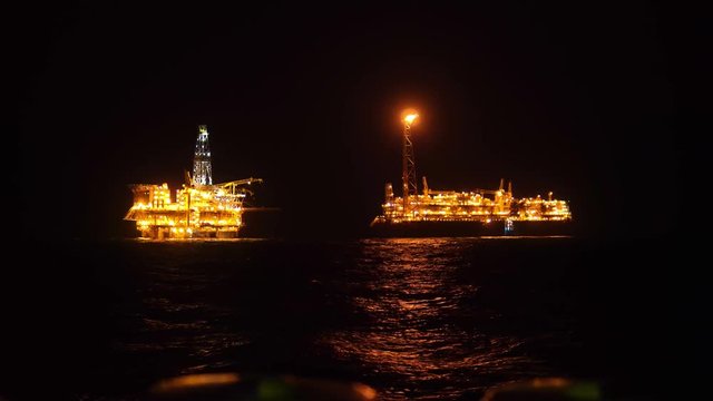 FPSO tanker vessel near Oil platform Rig. Offshore oil and gas industry, sea oil production and storage.