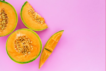 Yellow cantaloupe melon on pink background