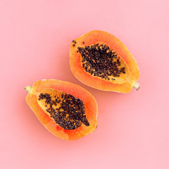 Half cut papaya on color background