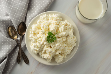 Cottage cheese isoalted on light, marble background. Dairy products, calcium and protein. Healthy breakfast.