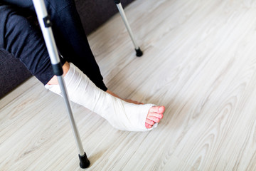 The man is trying to walk with a broken leg