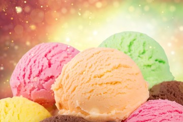 Chocolate, vanilla and strawberry ice cream in the cones on  background