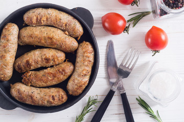 Grilled sausages with tomatoes , pepper and rosemary