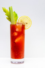 freshly made Bloody Mary cocktail or tomato juice, garnished with celery and lemon