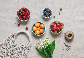 Picnic time. Handmade macrame bag on the linen background, ECO friendly. Strawberries, sweet...