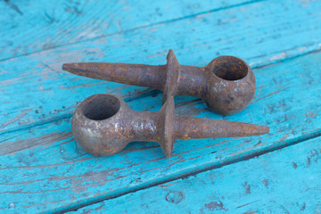 Background from old rusty bolts, screws, nuts, screws, brackets, various metal details. Rusty set of hand tools. blue wooden background. Vintage tools. Artisan work concept.