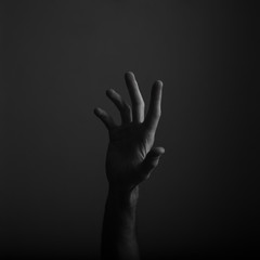 Fototapeta premium Male open hand gesture on a dark background