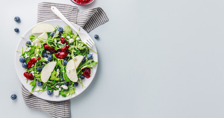 Summer salad with salad leaves, fruits, berries and cheese