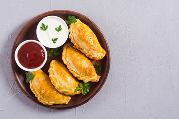 Latin American baked beef empanadas with sauce