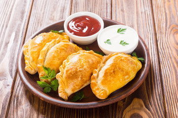 Latin American baked beef empanadas with sauce