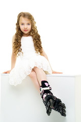 Little girl on roller skates.