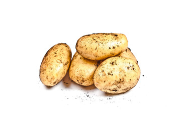 Newly harvested dirty potatoes heap isolated on white background.