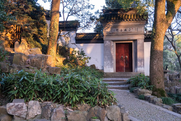 Fototapeta premium Ancient village white wall with red doors in the Tiger Hill park in China, Suzhou