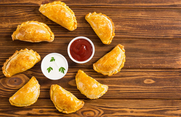 Latin American baked beef empanadas with sauce