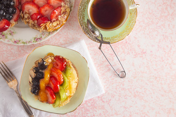 French Fruit Pastry on a China Plate on a Table Set for Tea