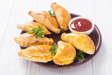 Latin American baked beef empanadas with sauce