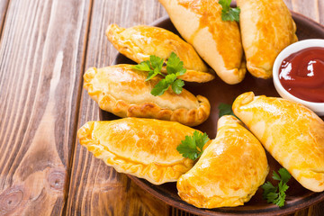 Latin American baked beef empanadas with sauce