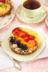 French Fruit Pastry on a China Plate on a Table Set for Tea