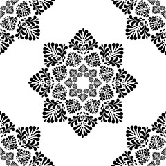 Seamless pattern of black and white stylized leaves geometrically located on white background