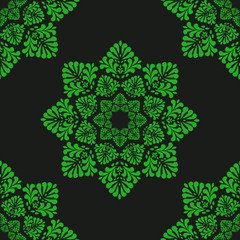 Seamless pattern of green stylized leaves geometrically located on black background