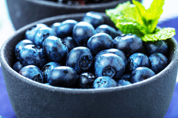Fresh Blueberries on blue background, top view. Juicy wild forest berries, bilberries. Healthy eating or nutrition