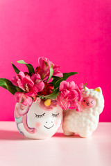 Unicorn mug with Alstroemeria and Squishy LLama on bright pink background. Idea of Girly settings. Vivid postcard for any holidays