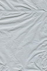 Transparent plastic wrap on the black background. Plastic bag texture. Reusable trash and waste.