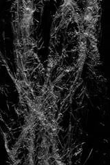 Transparent plastic wrap on the black background. Plastic bag texture. Reusable trash and waste.