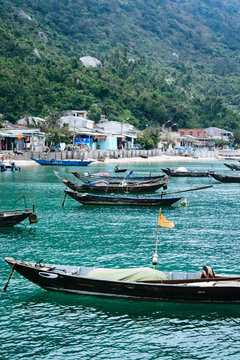 Traditional Vietnamese fishing boats at anchor, Cham island, Vietnam