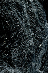 Transparent plastic wrap on the black background. Plastic bag texture. Reusable trash and waste.