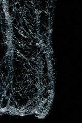 Transparent plastic wrap on the black background. Plastic bag texture. Reusable trash and waste.