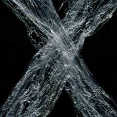 Transparent plastic wrap on the black background. Plastic bag texture. Reusable trash and waste.