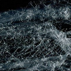 Transparent plastic wrap on the black background. Plastic bag texture. Reusable trash and waste.