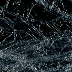 Transparent plastic wrap on the black background. Plastic bag texture. Reusable trash and waste.