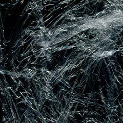 Transparent plastic wrap on the black background. Plastic bag texture. Reusable trash and waste.