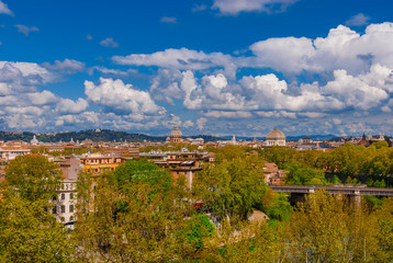 Fototapeta na wymiar Rome historic center old skyline above Trastevere with old churches, belltowers, domes and clouds, seen from Aventine Hill