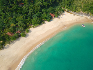 Aerial view of an amazing white sandy beach with turquoise water in tropical country. Amazing top view of sandy tropical beach. holiday destination. Palm and tropical beach with crystal clear water.